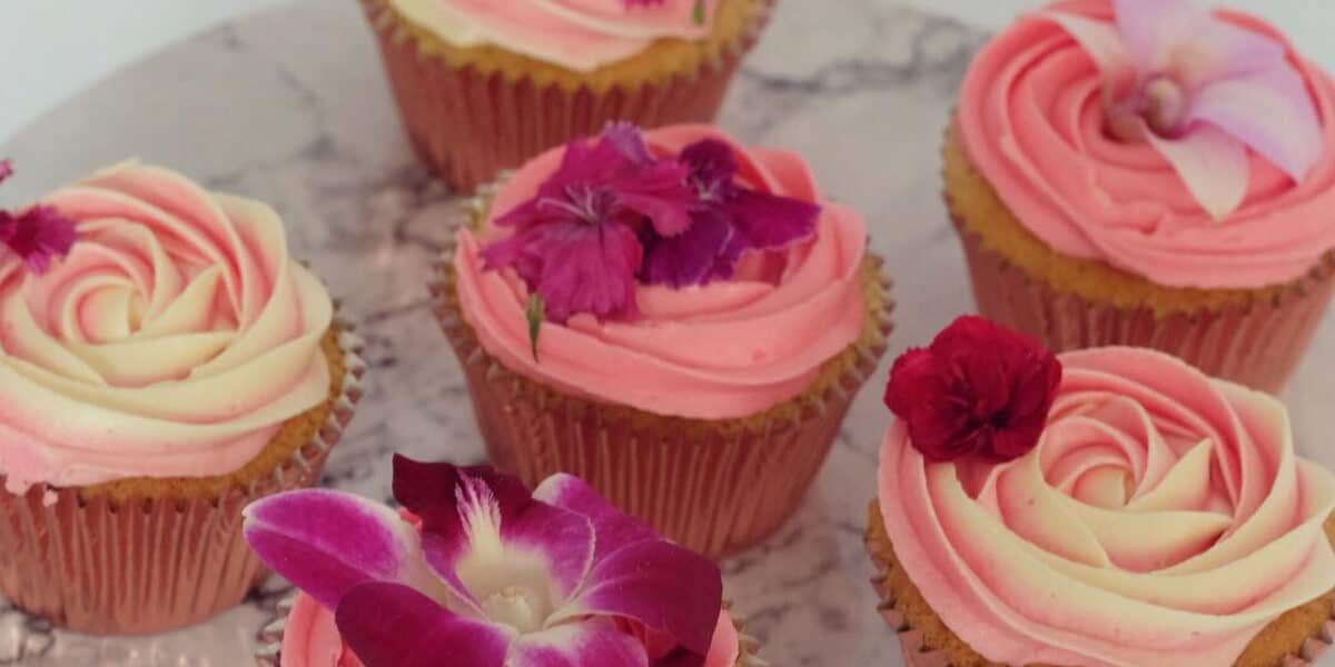 cupcakes garnished with edible carnation flowers