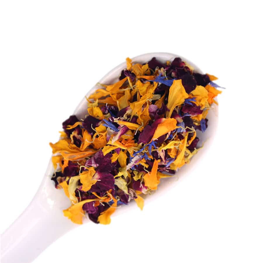 dried edible flower mix on a white spoon