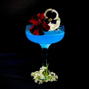 Royal Blue Cocktail topped with Edible Flowers